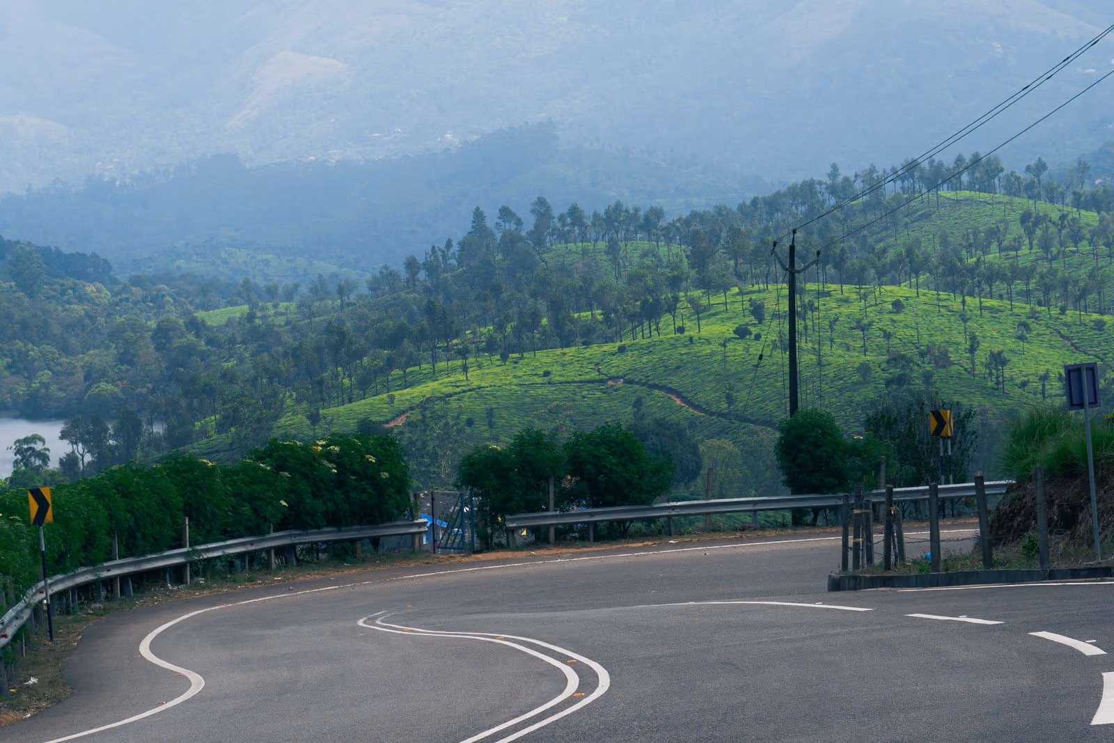 A winding mountain road through the tea plantations of Kerala